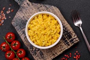 Delicious boiled yellow rice with turmeric, salt and spices photo