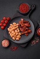 Fried sausages sliced with salt and spices as an ingredient for an English breakfast photo
