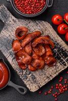 Fried sausages sliced with salt and spices as an ingredient for an English breakfast photo
