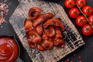 Fried sausages sliced with salt and spices as an ingredient for an English breakfast photo