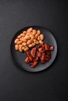 Fried sausages sliced with salt and spices as an ingredient for an English breakfast photo