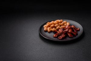 Fried sausages sliced with salt and spices as an ingredient for an English breakfast photo
