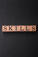 The inscription Skills made of wooden cubes on a plain background photo