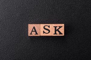 Inscription ASK wooden cubes, concept background with copy space photo