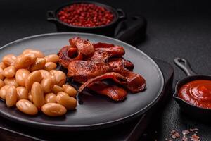 Fried sausages sliced with salt and spices as an ingredient for an English breakfast photo