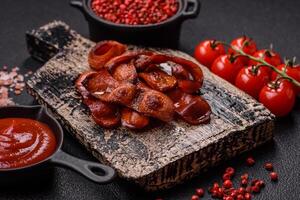 Fried sausages sliced with salt and spices as an ingredient for an English breakfast photo