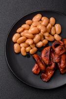 Fried sausages sliced with salt and spices as an ingredient for an English breakfast photo