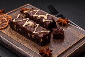Delicious sweet brownies with chocolate and nuts photo