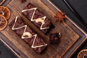 Delicious sweet brownies with chocolate and nuts photo