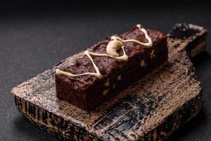 Delicious sweet brownies with chocolate and nuts photo