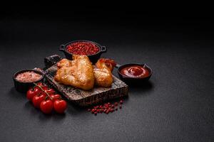 Delicious fried chicken wings with salt, spices and herbs photo