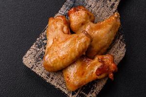 Delicious fried chicken wings with salt, spices and herbs photo