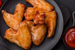 Delicious fried chicken wings with salt, spices and herbs photo