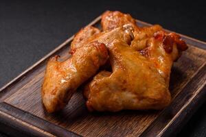 Delicious fried chicken wings with salt, spices and herbs photo
