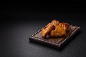 Delicious fried chicken wings with salt, spices and herbs photo