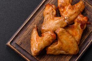 Delicious fried chicken wings with salt, spices and herbs photo