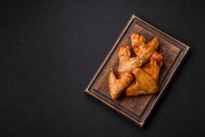 Delicious fried chicken wings with salt, spices and herbs photo