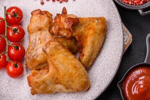 Delicious fried chicken wings with salt, spices and herbs photo