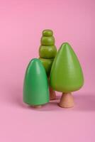 Wooden model of a tree with a green crown and trunk on a pink background photo