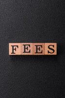 Inscription Fees with wooden cubes, conceptual background with copy space photo