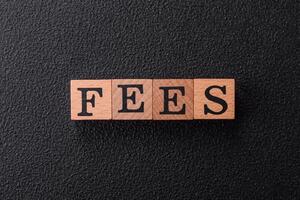 Inscription Fees with wooden cubes, conceptual background with copy space photo