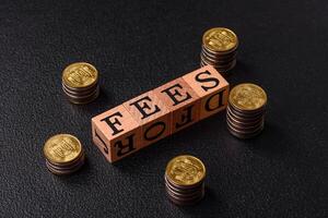 Inscription Fees with wooden cubes, conceptual background with copy space photo