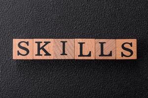 The inscription Skills made of wooden cubes on a plain background photo