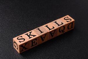 The inscription Skills made of wooden cubes on a plain background photo