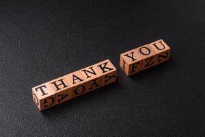 Inscription Thank you with wooden cubes, conceptual background with copy space photo