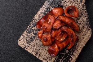 Fried sausages sliced with salt and spices as an ingredient for an English breakfast photo