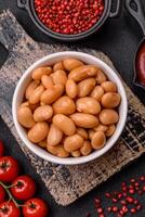 Delicious nutritious canned beans in tomato, with salt and spices photo