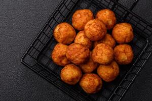 Delicious crispy balls breaded with mozzarella cheese, salt and spices photo