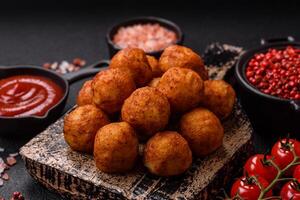 Delicious crispy balls breaded with mozzarella cheese, salt and spices photo