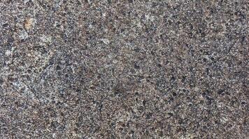 Rough, grey, dark harsh and high contrast granite stone texture background. A close-up of the surface of abstract natural rock. Natural Marble stone wallpaper. photo