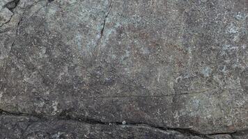 Rough, grey, dark harsh and high contrast granite stone texture background. A close-up of the surface of abstract natural rock. Natural Marble stone wallpaper. photo
