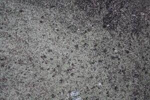 Rough, grey, dark harsh and high contrast granite stone texture background. A close-up of the surface of abstract natural rock. Natural Marble stone wallpaper. photo
