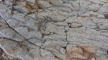 Rough, grey, dark harsh and high contrast granite stone texture background. A close-up of the surface of abstract natural rock. Natural Marble stone wallpaper. photo
