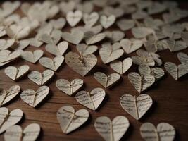 Handmade small paper hearts with strings. photo