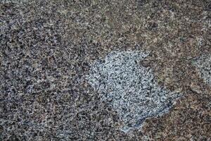 Rough, grey, dark harsh and high contrast granite stone texture background. A close-up of the surface of abstract natural rock. Natural Marble stone wallpaper. photo