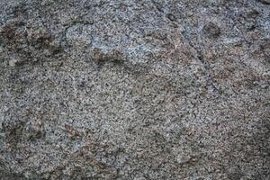Rough, grey, dark harsh and high contrast granite stone texture background. A close-up of the surface of abstract natural rock. Natural Marble stone wallpaper. photo