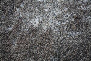 Rough, grey, dark harsh and high contrast granite stone texture background. A close-up of the surface of abstract natural rock. Natural Marble stone wallpaper. photo