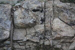 Rough, grey, dark harsh and high contrast granite stone texture background. A close-up of the surface of abstract natural rock. Natural Marble stone wallpaper. photo