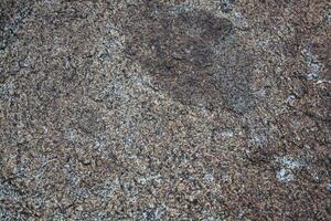 Rough, grey, dark harsh and high contrast granite stone texture background. A close-up of the surface of abstract natural rock. Natural Marble stone wallpaper. photo