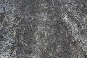 Rough, grey, dark harsh and high contrast granite stone texture background. A close-up of the surface of abstract natural rock. Natural Marble stone wallpaper. photo