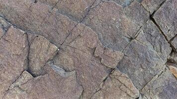 Rough, grey, dark harsh and high contrast granite stone texture background. A close-up of the surface of abstract natural rock. Natural Marble stone wallpaper. photo