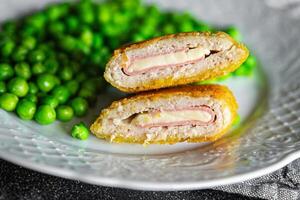 cutlet cordon bleu chicken meat, cheese, bacon meal snack on the table copy space food background rustic top view photo
