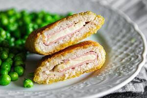 cutlet cordon bleu chicken meat, cheese, bacon meal snack on the table copy space food background rustic top view photo