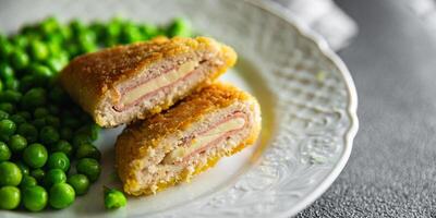 cutlet cordon bleu chicken meat, cheese, bacon meal snack on the table copy space food background rustic top view photo