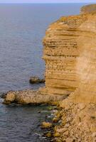 Cormorants rest on a steep bank of Pontic limestone in eastern Crimea photo