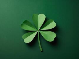 St Patrick Day concept Paper art and craft style four-leaf clover on green background Flat lay, top view, vertical. photo